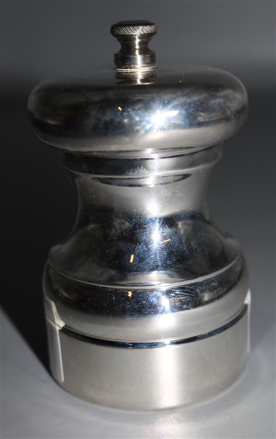 A large silver pepper mill
